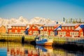 SVOLVAER, LOFOTEN ISLANDS, NORWAY - APRIL 10, 2018: Outdoor view of harbor houses in Svolvaer, with a boat in the shore