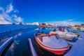 SVOLVAER, LOFOTEN ISLANDS, NORWAY - APRIL 10, 2018: View of fishing boats covered with snow in harbour with buildings in