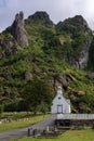 Svolvaer cemetery. White and blu chapel at the foot of a rocky mountain