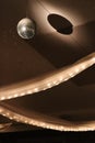 Swags of lights in tulle and glittering disco ball hanging from ceiling, vertical Royalty Free Stock Photo