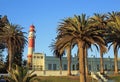 Scenic Swakopmund Mole - with lighthouse, palm trees and blue sky Royalty Free Stock Photo