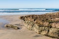 Swami`s Beach at Low Tide With Rocky Reef Covered by Barnacles