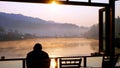 Swamp and white mist with Green mountain and orange sunshine background.