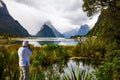 Swampy coast. The gray-haired tourist photographs