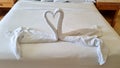 swan folded from white towels on bed in an old hotel room, top view Royalty Free Stock Photo