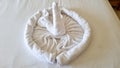 swan folded from white towels on bed in an old hotel room, top view Royalty Free Stock Photo