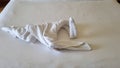 swan folded from white towels on bed in an old hotel room, top view Royalty Free Stock Photo