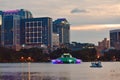 Swan paddle boats for rent at Lake Eola Park and colorful fountain on beatiful sunset Royalty Free Stock Photo