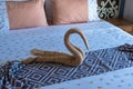 Swan shaped towel on the bed.concept travel