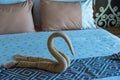 Swan shaped towel on the bed.concept travel