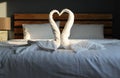 Swan shaped white towel on the bed