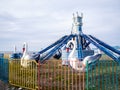 Swans on a carousel. Abandoned Luna Park on the seashore. A crisis. Old carousels. Not working. Broken attraction. resort in