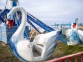 Swans on a carousel. Abandoned Luna Park on the seashore. A crisis. Old carousels. Not working. Broken attraction. resort in