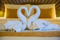 Swans made from towels on the bed Royalty Free Stock Photo
