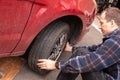 Swapping winter wheels and tires to summer on your car. Break bar and Car jack being used