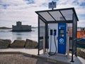 A SWARCO ChargePlace Scotland EV charging point at the harbour of Castlebay on the island of Barra in the Outer Hebrides, Scotland Royalty Free Stock Photo