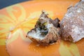 A swarm of wasps flies on a plate and eats fried meat. Food waste and insects