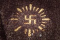 Swastika carved and drawn on a rock - an ancient solar hinduism symbol in the Indonesian culture