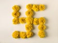 Swastika - a Hindu religious symbol made with fresh and bright golden yellow Marigold flowers.