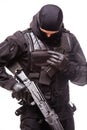 SWAT officer with assault rifle in black uniform isolated on white