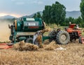 Swat, Pakistan - 24 May 2023: Tractor with thresher machine operating in the agriculture field in swat valley of Pakistan