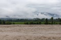 Swat river flood after heavy rain, agriculture land submerged under flood water during monsoon season with white clouds on Royalty Free Stock Photo