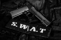 SWAT Special weapons and tactics team equipment with hand gun on black uniform background Royalty Free Stock Photo