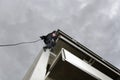 SWAT Team Officer Rappelling and Aiming Gun