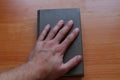 The hand on the book