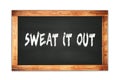 SWEAT  IT  OUT text written on wooden frame school blackboard Royalty Free Stock Photo