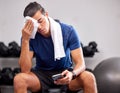 Sweat, tired and man resting in the gym after a intense workout, exercise sports training. Fitness, sport and male
