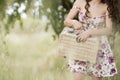 Sweat young woman holding a retro picnic basket