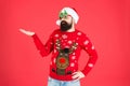 Sweater with deer. Clothes shop. Buy festive clothing. Holidays accessories. Hipster bearded man wear winter sweater and Royalty Free Stock Photo