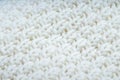 Sweater or scarf White Crocheted Fabric Texture, large knitting. Knitted jersey background with a relief pattern. Wool hand- Royalty Free Stock Photo