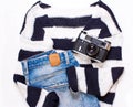 Sweater in white and blue stripes, jeans, and a camera