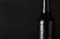 Sweating, cold bottle of beer closeup on black background Royalty Free Stock Photo