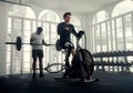 Sweating Paralympic athlete riding an airbike in a modern gym . Royalty Free Stock Photo
