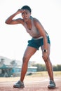 Sweating, tired and black woman at stadium for a race, training or breathing after cardio. Sports, workout and an Royalty Free Stock Photo