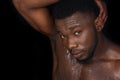 sweaty bare chested young african american man posing and looking at camera Royalty Free Stock Photo