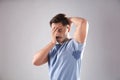 Sweaty man with stain on t-shirt against gray background Royalty Free Stock Photo