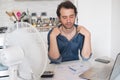 Sweaty man trying to refresh from heat with fan Royalty Free Stock Photo