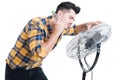 Sweaty and thirsty man standing near fan and cooling off Royalty Free Stock Photo