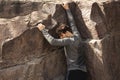 Sweaty young man climbing rock wall Royalty Free Stock Photo