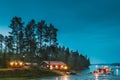 Sweden. Sweden. Beautiful Red Swedish Wooden Log Cabin House On Rocky Island Coast In Summer Night Evening. Lake Or Royalty Free Stock Photo