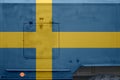 Sweden flag depicted on side part of military armored truck closeup. Army forces conceptual background