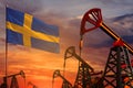 Sweden oil industry concept. Industrial illustration - Sweden flag and oil wells with the red and blue sunset or sunrise sky Royalty Free Stock Photo