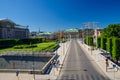 Sweden, Stockholm, May 31, 2018: Riksplan green grass lawn, bushes and street with national flags