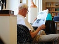 Sweden - Stockholm - old man reading a newspaper in library Royalty Free Stock Photo