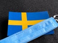 Sweden, Swedish flag is near a blue mask on the dark gray background. Tourist trip. European Football Championship