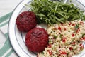 Beet cutlets with couscous and arugula